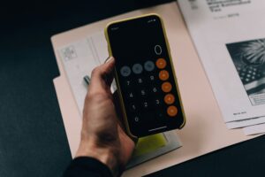 電卓で税額を計算しながら帳簿を確認している手元