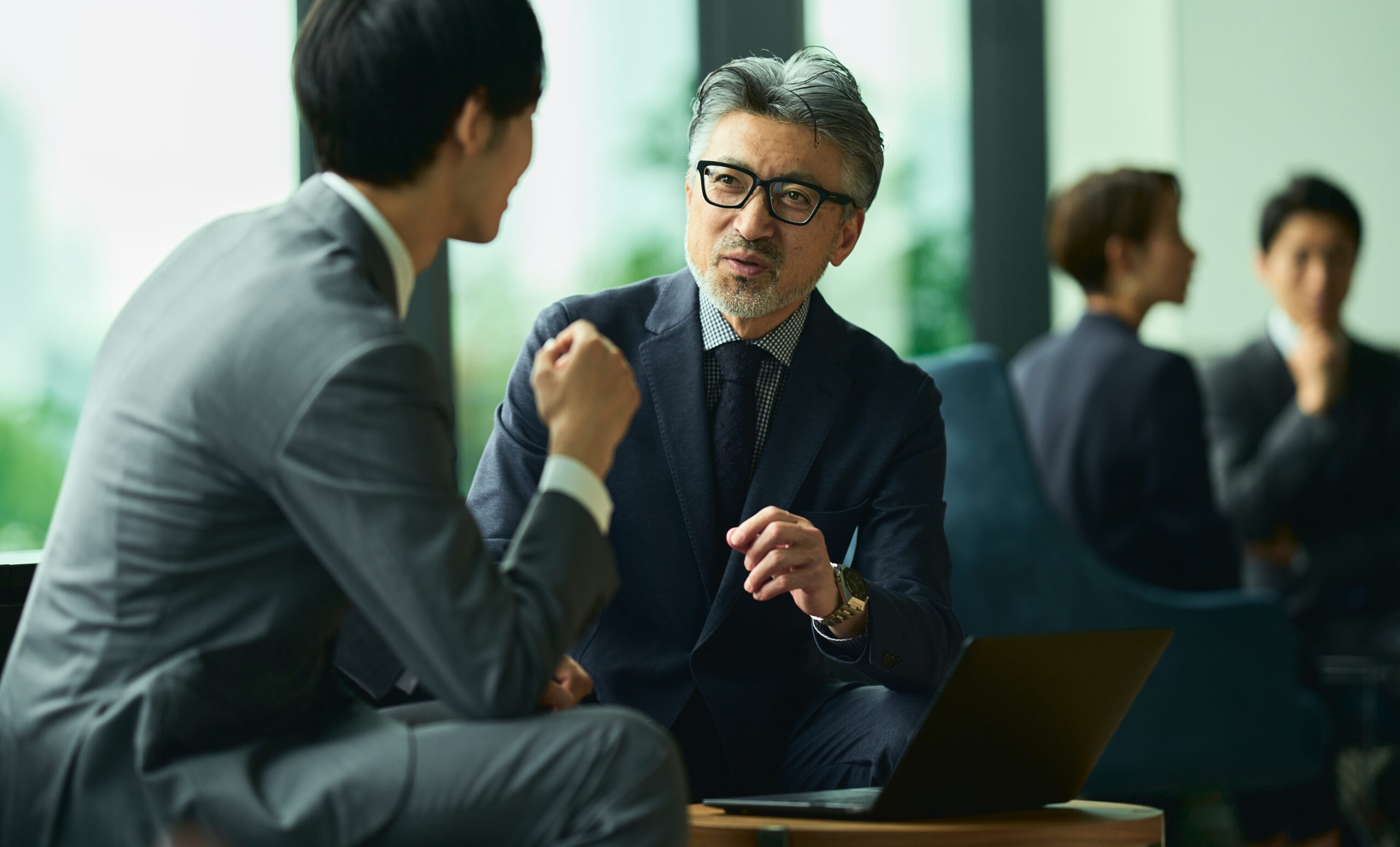 Businessmen,Having,A,Meeting,In,The,Lounge