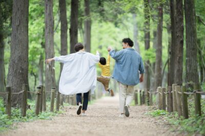 A,Smiling,Japanese,(asian),Family,Of,Three,Walking,Hand,In